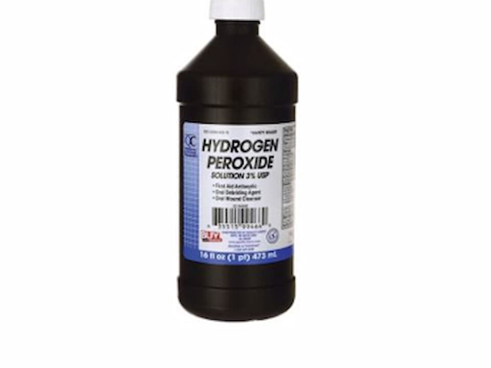 Brown plastic bottle with a white cap, labeled hydrogen peroxide solution 3%, blue and white label, 16 fl oz (473 ml)