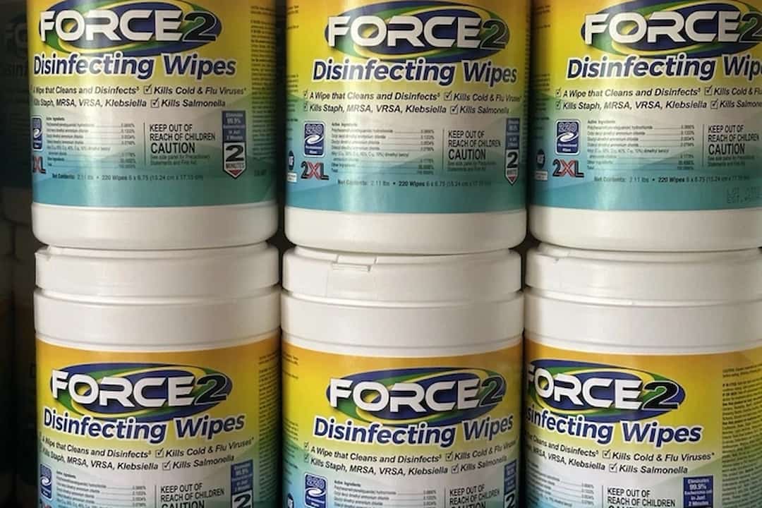 Six containers of Force2 disinfecting wipes, labeled to kill viruses and bacteria, arranged on a store shelf
