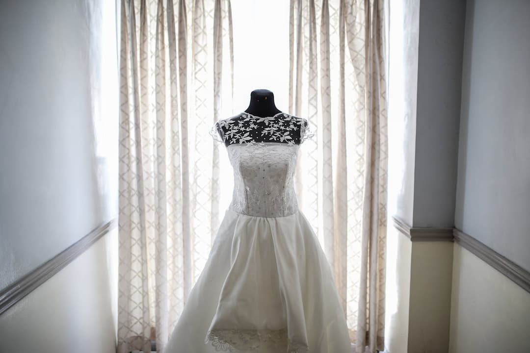bridal gown waiting for a fitting, wedding preparations in a bridal suite, boutique display for wedding attire, styled photoshoot before the ceremony, sentimental keepsake from a past wedding